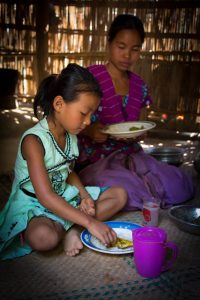 A young girl eating lunch in Khagrachari, Bangladesh (Photo credit: IFPRI PSSRP Bangladesh)
